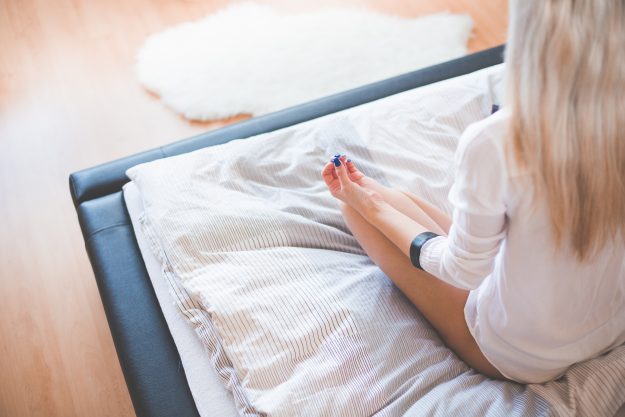 young-girl-starting-new-day-with-meditation-in-her-bed-picjumbo-com